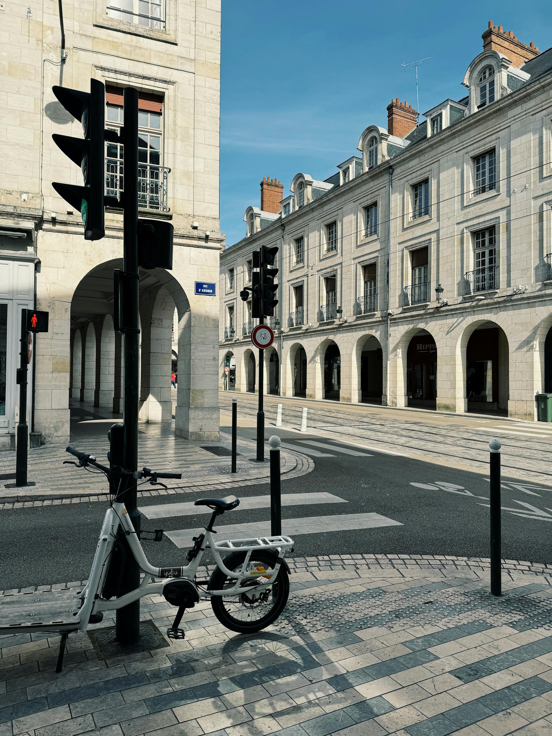 Tranquil urban street in Orléans, France, featuring parked bicycle and classic architecture.